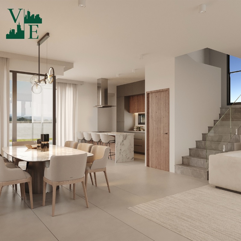 Jasne wnętrze domu z marmurowym stołem jadalnym, kuchnią z wyspą i schodami. Nowoczesny design z widokiem na zewnątrz przez duże okno.