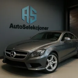 Szary Mercedes-Benz CLS z aluminiowymi felgami na tle ściany z logo 'AutoSeleksjoner'. Auto w salonie, oświetlenie studyjne, elegancki design.