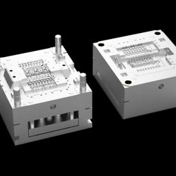 KD PRODUCTS Klaudia Gniazdowska - Precyzyjna forma wtryskowa z widocznymi detalami obróbki, na czarnym tle. Dwie części formy, ukazujące skomplikowaną konstrukcję i dokładność wykonania.