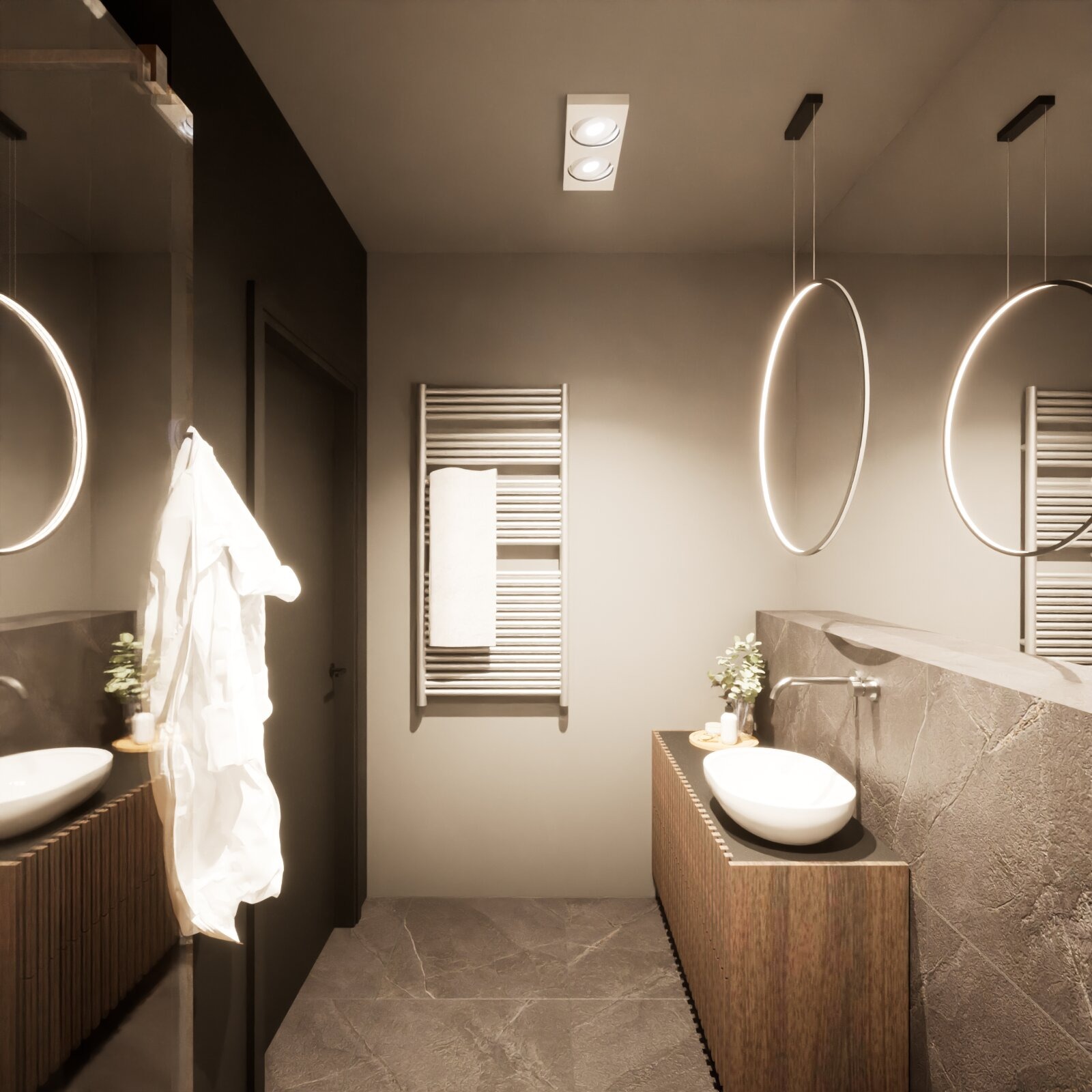 Nowoczesna łazienka z umywalką nablatową i okrągłymi lustrami z podświetleniem LED. Na ścianie grzejnik drabinkowy z ręcznikiem. Minimalistyczny design.