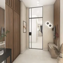 Neutralny hol z drewnianą zabudową, ławką i dekoracjami. Czarne, okrągłe lampy na ścianie. Widok na dalszą część mieszkania przez szklane drzwi.