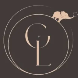 Eleganckie logo z inicjałami 'GL' w okręgu i motywem słonia, utrzymane w stonowanej, beżowo-brązowej kolorystyce. Minimalistyczny design.