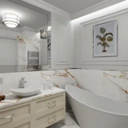 Elegancka łazienka w bieli i złocie: owalna wanna, umywalka nablatowa, marmurowe ściany z dekoracyjną ramą i grafiką. Lustro odbija nowoczesne oświetlenie.