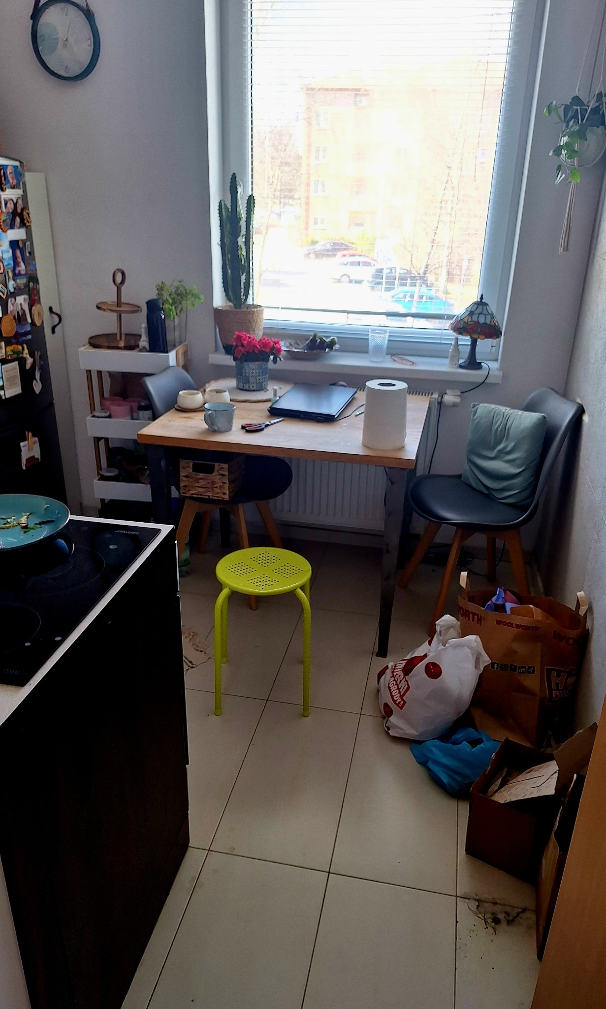 Kuchnia po sprzątaniu w Zielonej Górze: czyste płytki, uporządkowany stół z dekoracjami, okno z widokiem na zewnątrz, brak widocznego bałaganu, schludne otoczenie.