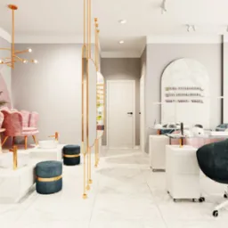 Nowoczesne wnętrze salonu kosmetycznego z różowymi fotelami, marmurowymi elementami i złotymi akcentami. Widoczne stanowiska do manicure i pedicure.