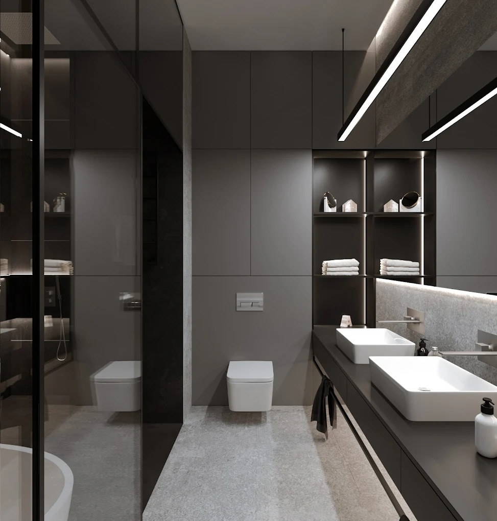 Nowoczesna, szara łazienka w Łodzi z podwójną umywalką, oświetleniem LED i minimalistyczną toaletą podwieszaną. Widoczne półki z dekoracjami i szklana kabina prysznicowa.