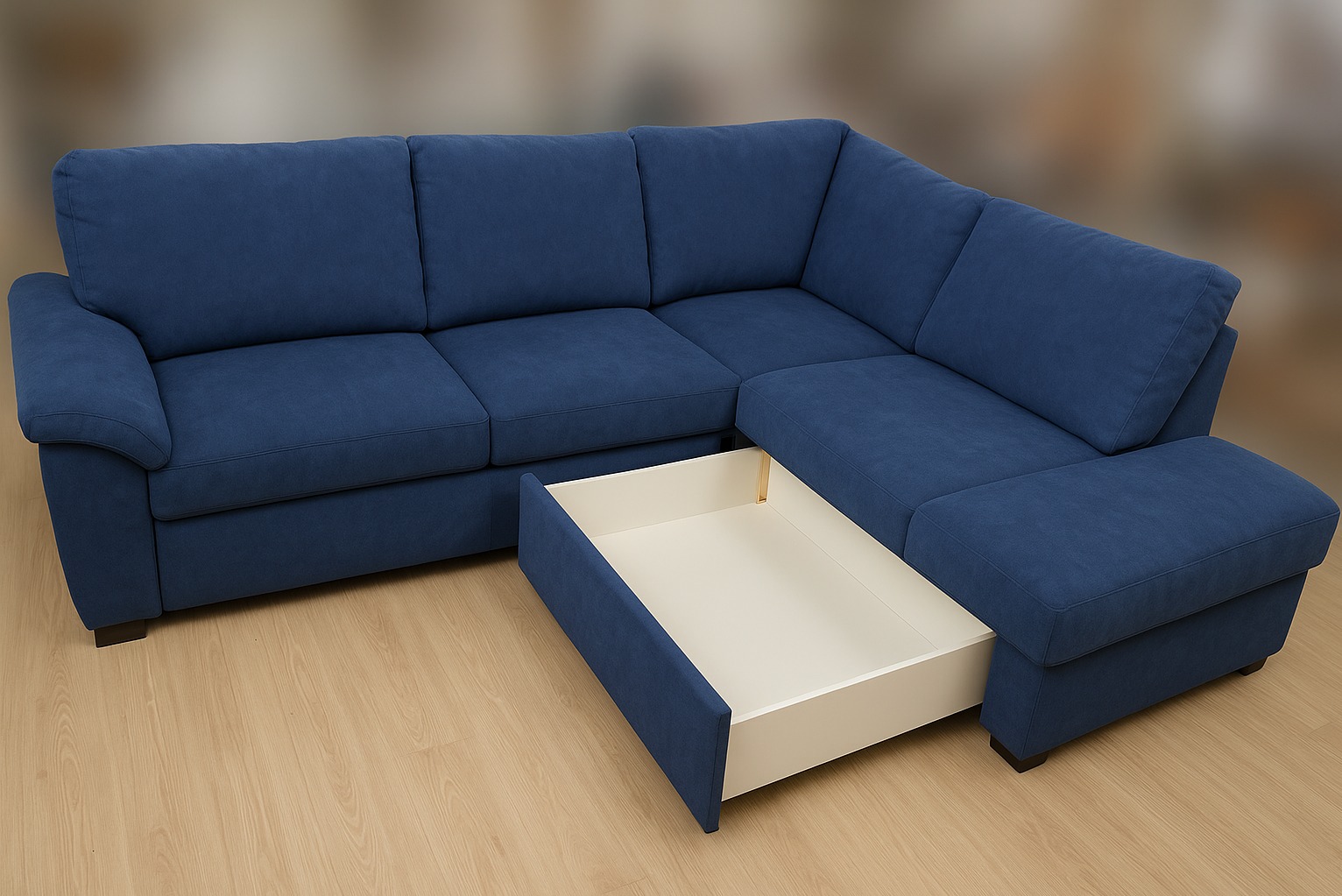 Narożnik z niebieską tapicerką i wysuwaną szufladą. Widoczne subtelne nóżki i drewniana podłoga. Nowoczesny design i praktyczne rozwiązanie do przechowywania.