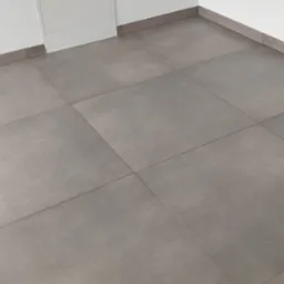 Szare, matowe płytki podłogowe ułożone w minimalistycznym wnętrzu. Widoczna biała ściana z dostępem rewizyjnym i szare listwy przypodłogowe.