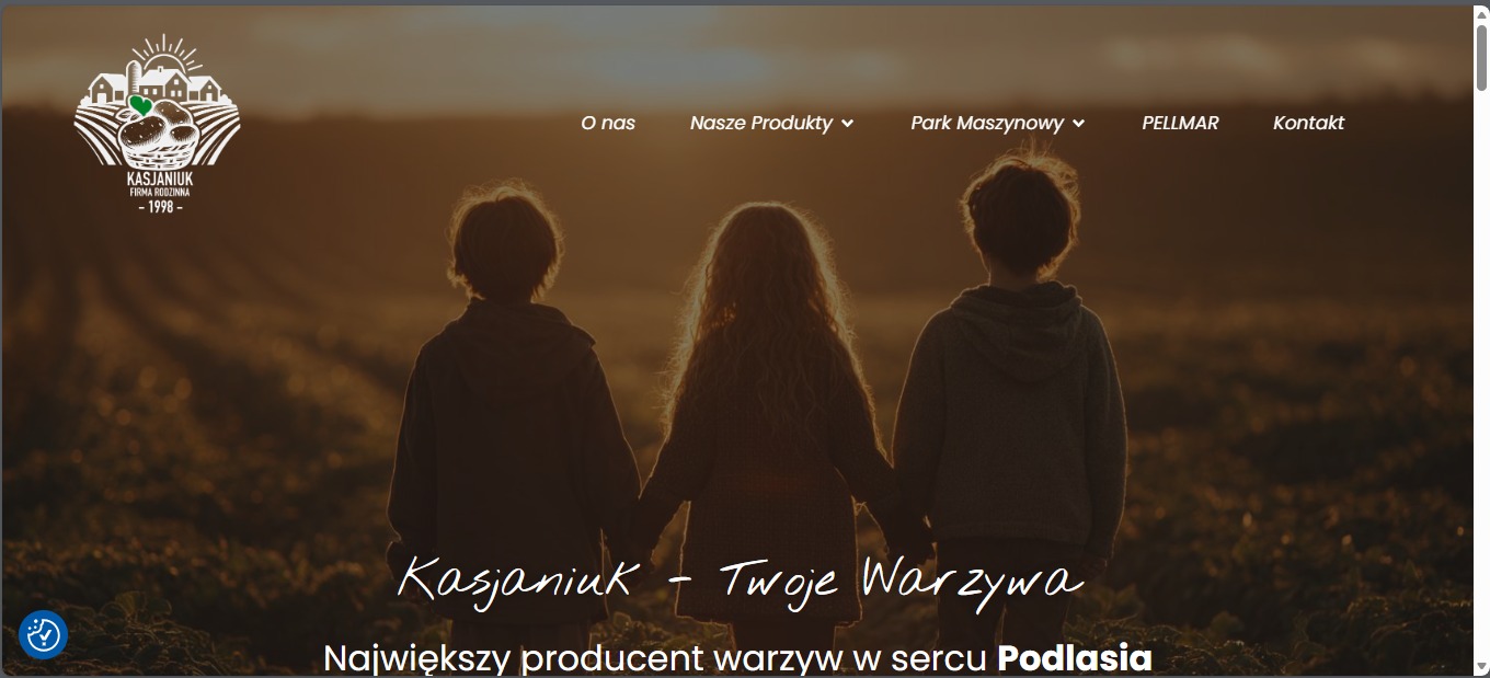Strona internetowa firmy Kasjaniuk z motywem dzieci na tle pola warzyw, z logo i menu nawigacyjnym. Ciepłe, zachodzące słońce w tle.