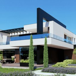 ChatGPT said:

Luksusowa willa o modernistycznej bryle z dużymi przeszkleniami, białą elewacją i kontrastującymi czarnymi akcentami, otoczona eleganckim ogrodem.