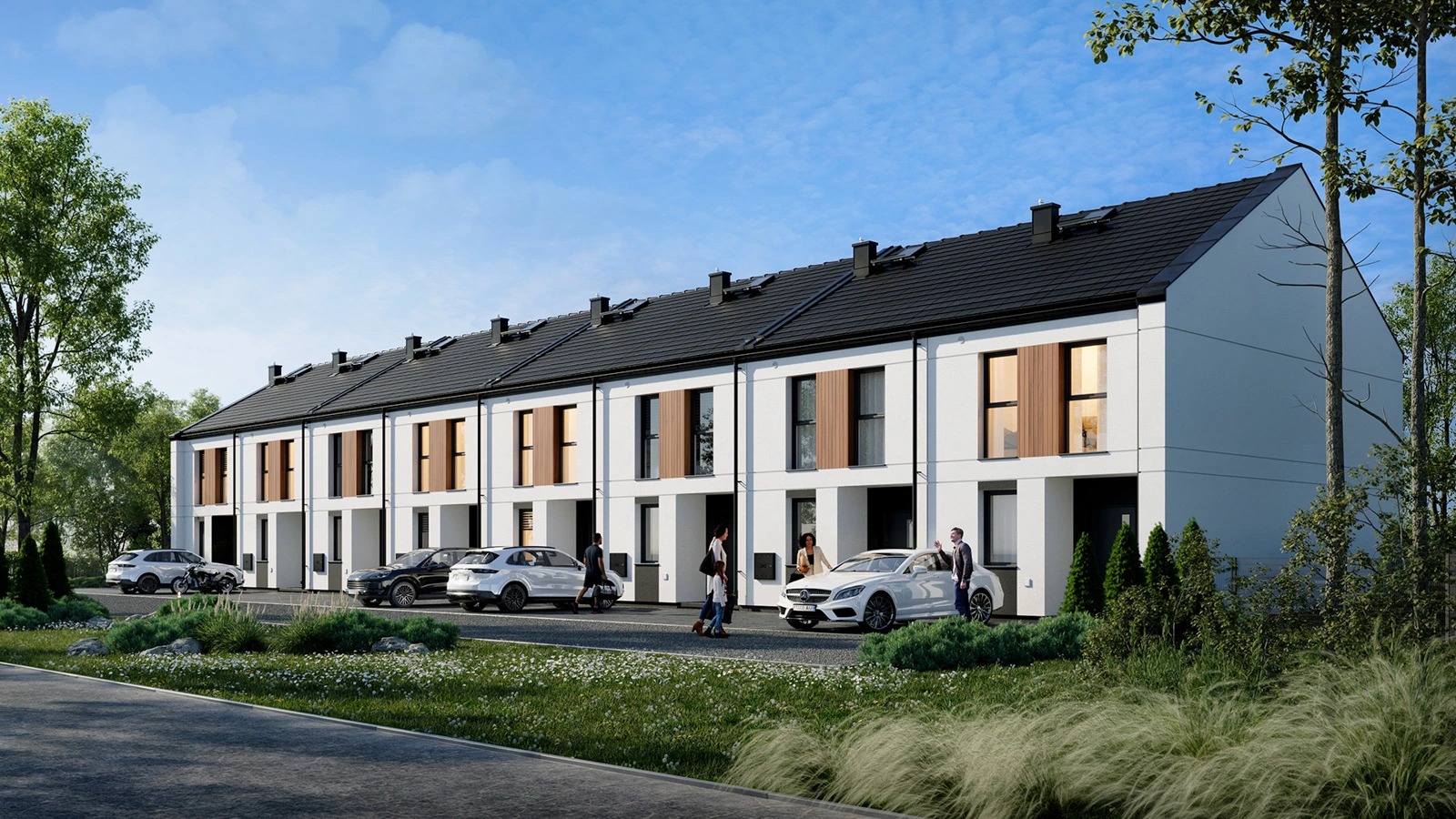 Szereg nowoczesnych, dwukondygnacyjnych domów z czarnymi dachami i drewnianymi akcentami na elewacji. Przed budynkami zaparkowane auta i spacerujący ludzie.