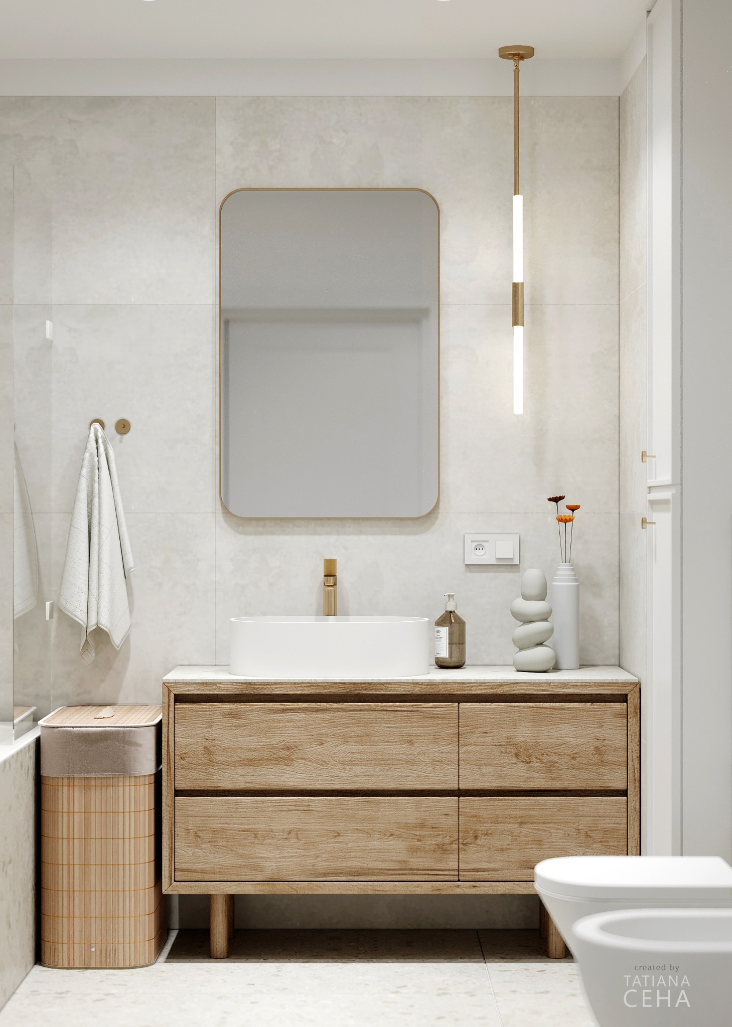 Jasna łazienka z drewnianą szafką pod umywalką, minimalistycznym lustrem w złotej ramie i wiszącą lampą. Umywalka nablatowa, dekoracje i kosz z bambusa.