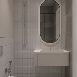 TARBAEV ARCHITECTS Eugeniusz Tarbayev - Minimalistyczna łazienka z podświetlanym lustrem w kształcie zaokrąglonego prostokąta, białą umywalką z szafką i wiszącą toaletą. Szare płytki na ścianach i podłodze.