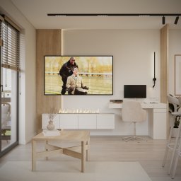 TARBAEV ARCHITECTS Eugeniusz Tarbayev - Jasne wnętrze z biokominkiem pod telewizorem, drewnianymi akcentami i biurkiem. Minimalistyczny design z elementami naturalnego drewna i subtelnym oświetleniem.