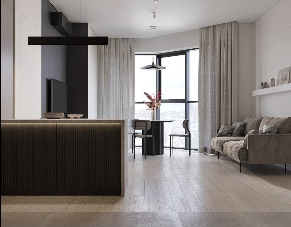 Nowoczesne wnętrze: minimalistyczna kuchnia z wyspą, jadalnia z okrągłym stołem i salon z sofą w stonowanych barwach, duże okno, drewniana podłoga.