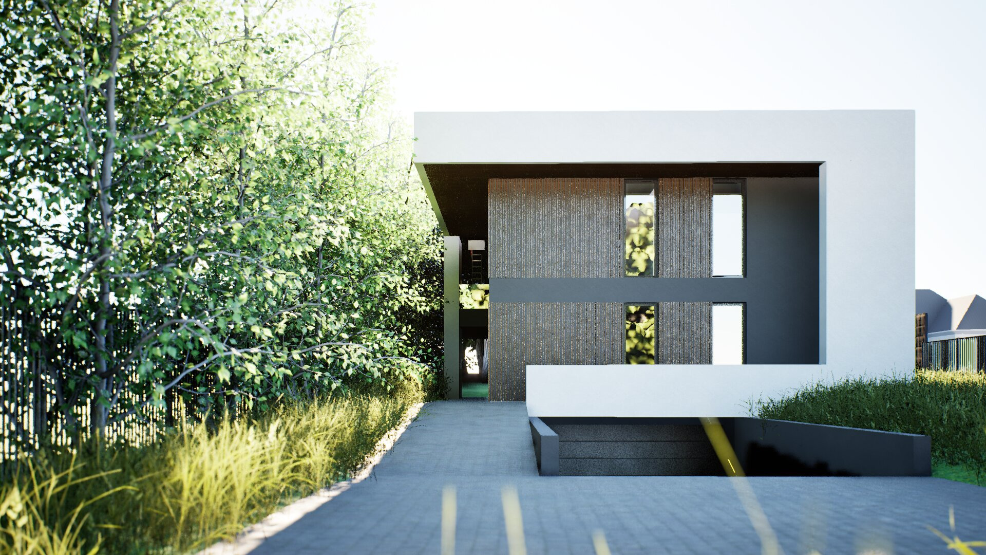 Nowoczesny dom z garażem podziemnym, otoczony zielenią. Elewacja z szarego betonu i białych elementów architektonicznych. Widok z poziomu podjazdu.