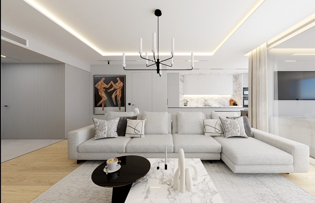 Nowoczesny salon z narożną sofą, czarnym stolikiem kawowym i marmurowym blatem, oświetlony designerską lampą wiszącą. W tle widoczna kuchnia i obraz na ścianie.