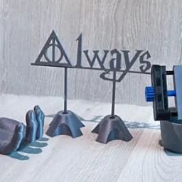 Drukowane w 3D: napis 'Always' z symbolem Insygniów Śmierci, model dłoni i narzędzie mocujące, wszystko w szarym odcieniu na jasnym tle.