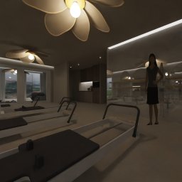 RINNOVO Usługi Budowlano Wykończeniowe Łukasz Bańcerowsk & Dash.Interior - Jasne wnętrze sali do ćwiczeń pilates z sprzętem do ćwiczeń, lustrami i osobami ćwiczącymi. Kwiatowe lampy sufitowe dodają unikalnego charakteru.