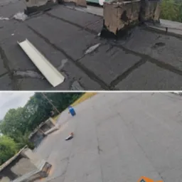 Dach pokryty papą z kominami przed i po renowacji. Widoczna nowa obróbka komina i fragment rynny. Na drugim planie budynek i zieleń.