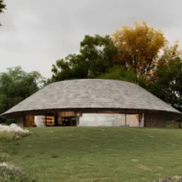 Nowoczesny, okrągły dom z kamienia i drewna, kryty gontem, wkomponowany w zielony krajobraz. Duże przeszklenia zapewniają naturalne światło. Architektura ekologiczna.
