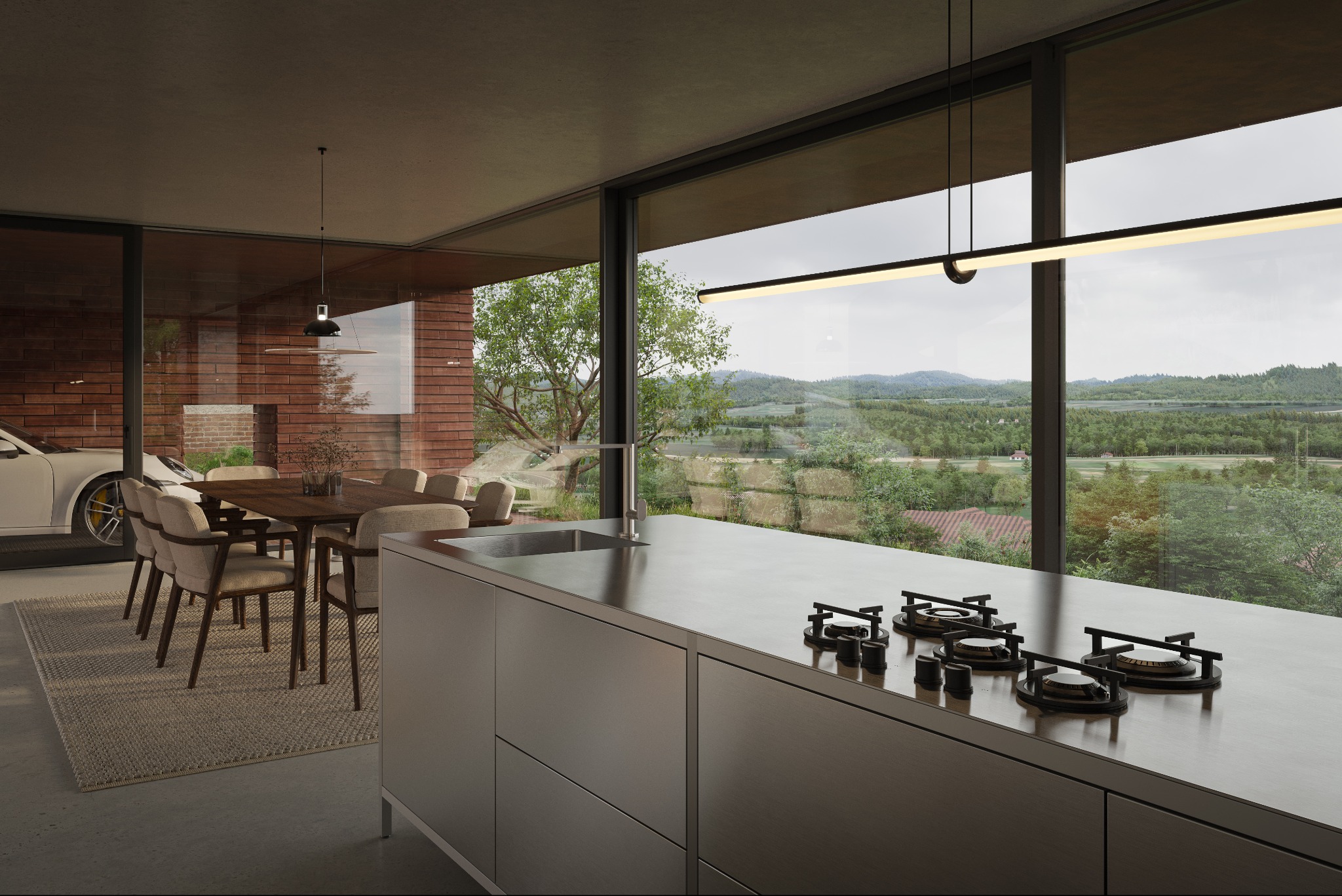 Nowoczesna kuchnia z wyspą i widokiem na krajobraz, minimalistyczny design, duże okna, stół z krzesłami, częściowo widoczny samochód w garażu.
