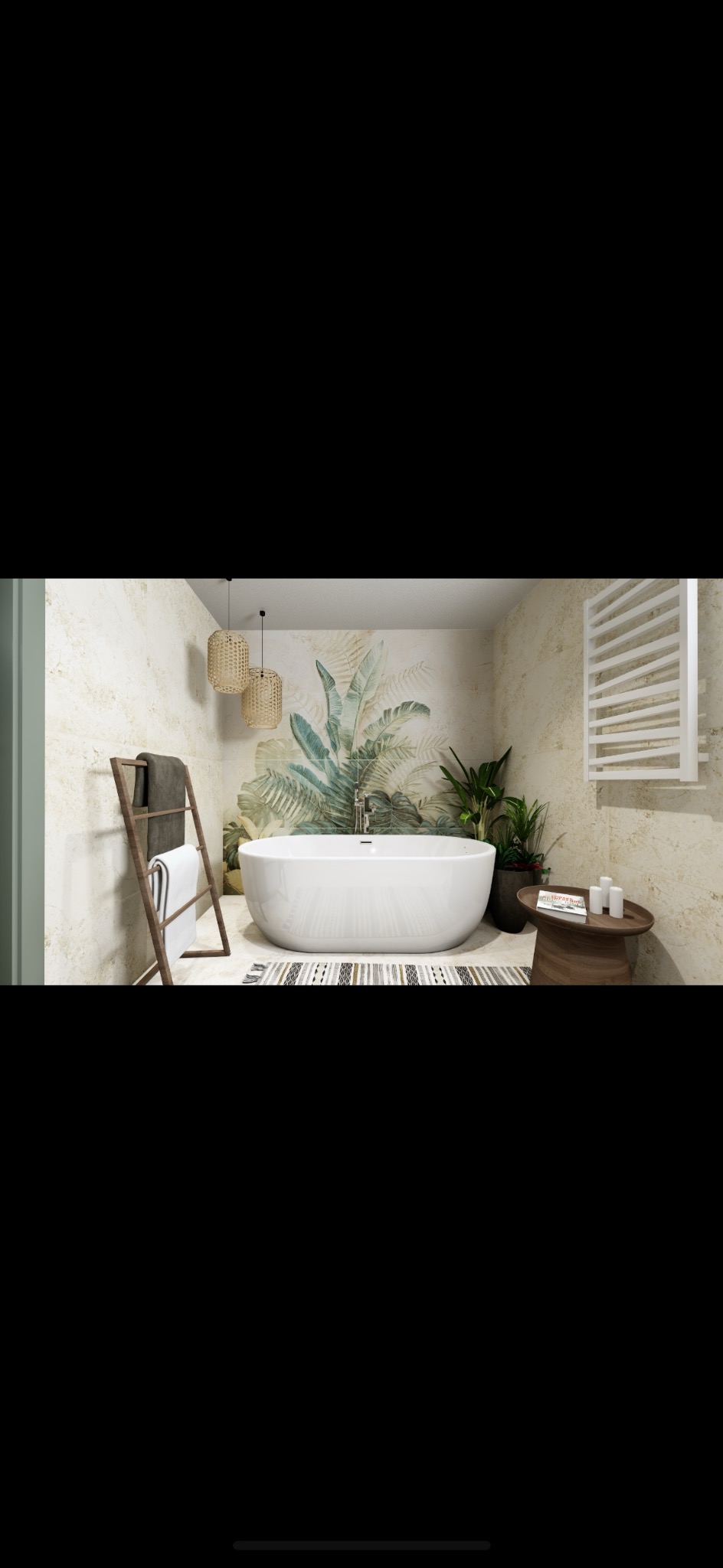 Nowoczesna łazienka z wolnostojącą wanną na tle ściany z motywem roślinnym, drewnianym wieszakiem na ręczniki i grzejnikiem drabinkowym.