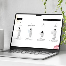 GWDesign Grzegorz Wieliczko - Laptop prezentuje stronę internetową z ofertą kosmetyków do pielęgnacji skóry trądzikowej. Widoczne cztery produkty z cenami i opcją dodania do koszyka. Minimalistyczny design.