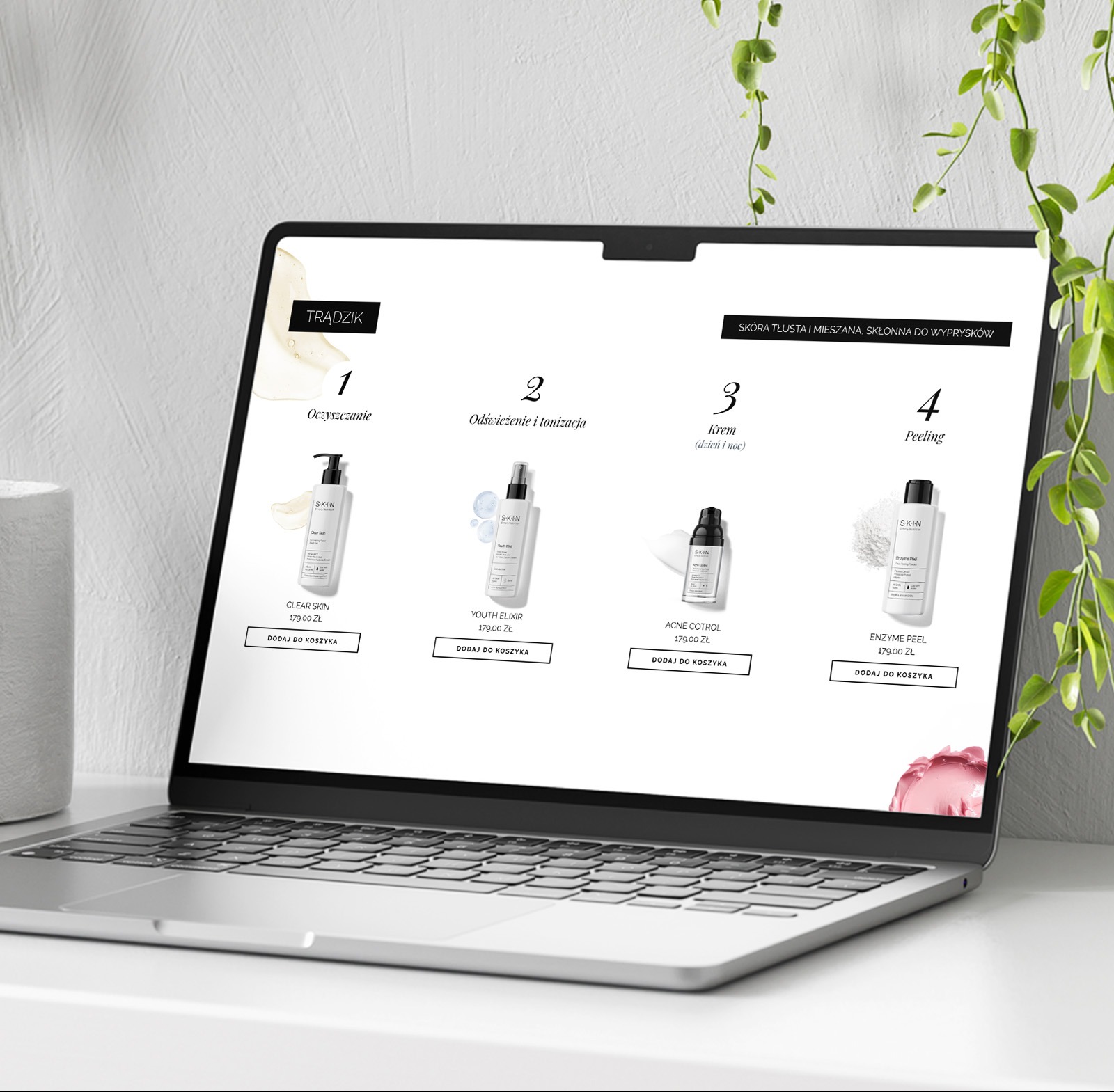 Laptop prezentuje stronę internetową z ofertą kosmetyków do pielęgnacji skóry trądzikowej. Widoczne cztery produkty z cenami i opcją dodania do koszyka. Minimalistyczny design.