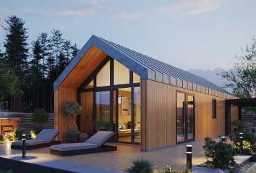 Nowoczesny dom modułowy z jasną elewacją drewnianą, dużymi przeszkleniami i tarasem z leżakami, otoczony zielenią, oświetlony lampami. Architektura w minimalistycznym stylu.
