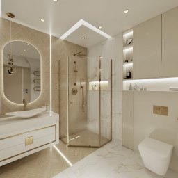 Design Atelier by Maria Słodowska - Elegancka łazienka w beżach i bieli: kabina prysznicowa ze złotymi detalami, umywalka na szafce z ozdobnymi uchwytami, lustro z podświetleniem LED, złote akcenty.
