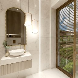 Design Atelier by Maria Słodowska - Elegancka łazienka z marmurowymi ścianami, owalną umywalką nablatową, lustrem w złotej ramie i oknem z żaluzjami. Minimalistyczne oświetlenie.