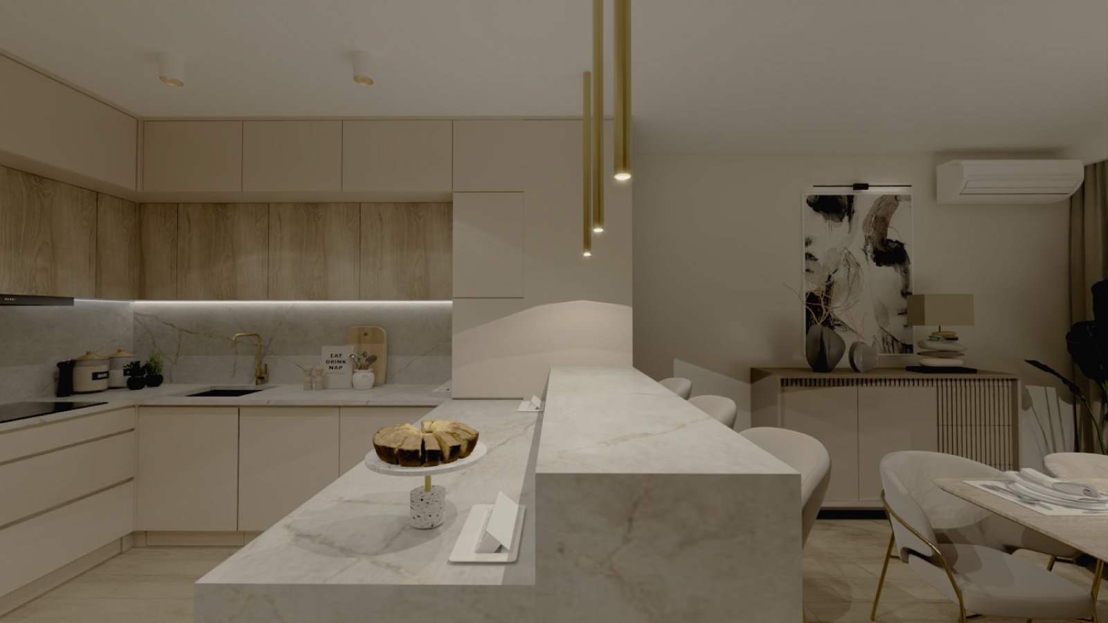 Beżowa kuchnia z marmurowym blatem i złotymi lampami wiszącymi. Na blacie ciasto. W tle obraz na ścianie i klimatyzator. Minimalistyczny styl.