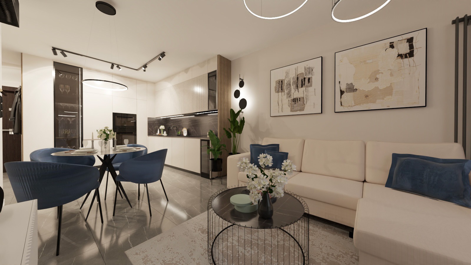 Nowoczesne wnętrze: jasny salon z aneksem kuchennym, okrągły stół z krzesłami w odcieniach niebieskiego, beżowa sofa z poduszkami i minimalistyczne obrazy na ścianie.