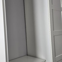 PLZ Painting And Decorating LTD - Świeżo pomalowana, szara ściana w rogu pokoju, sąsiadująca z białą szafą z szufladami. Minimalistyczny design, gładkie powierzchnie, subtelne oświetlenie.