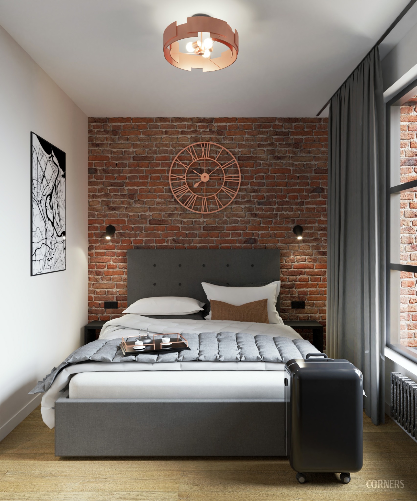Nowoczesna sypialnia z ceglaną ścianą, łóżkiem z szarą ramą i walizką. Miedziany zegar i lampa dodają ciepła wnętrzu. Na ścianie grafika, okno z zasłoną.