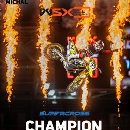 PR Graphics Zumkowski-Pawłowicz - Michał Pawłowicz na żółtym motocyklu crossowym w locie podczas World Supercross Championship, otoczony pionowymi słupami ognia, z napisem 'Champion of the World'.