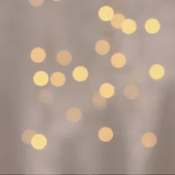 Rozmyte, ciepłe światła bokeh na delikatnym, beżowym tle. Idealne do subtelnych projektów graficznych i wizualizacji świątecznych.