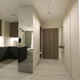 KoNo Interiors Kamila Konopka - Wnętrze mieszkania z widokiem na kuchnię, salon i przedpokój. Minimalistyczny design, jasne kolory, drewniane akcenty. Nowoczesne oświetlenie.