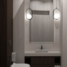 KoNo Interiors Kamila Konopka - Nowoczesna łazienka z umywalką, toaletą i lustrem w kształcie łuku, oświetlona wiszącymi lampami. Minimalistyczny design z drewnianymi akcentami i marmurowym wykończeniem.