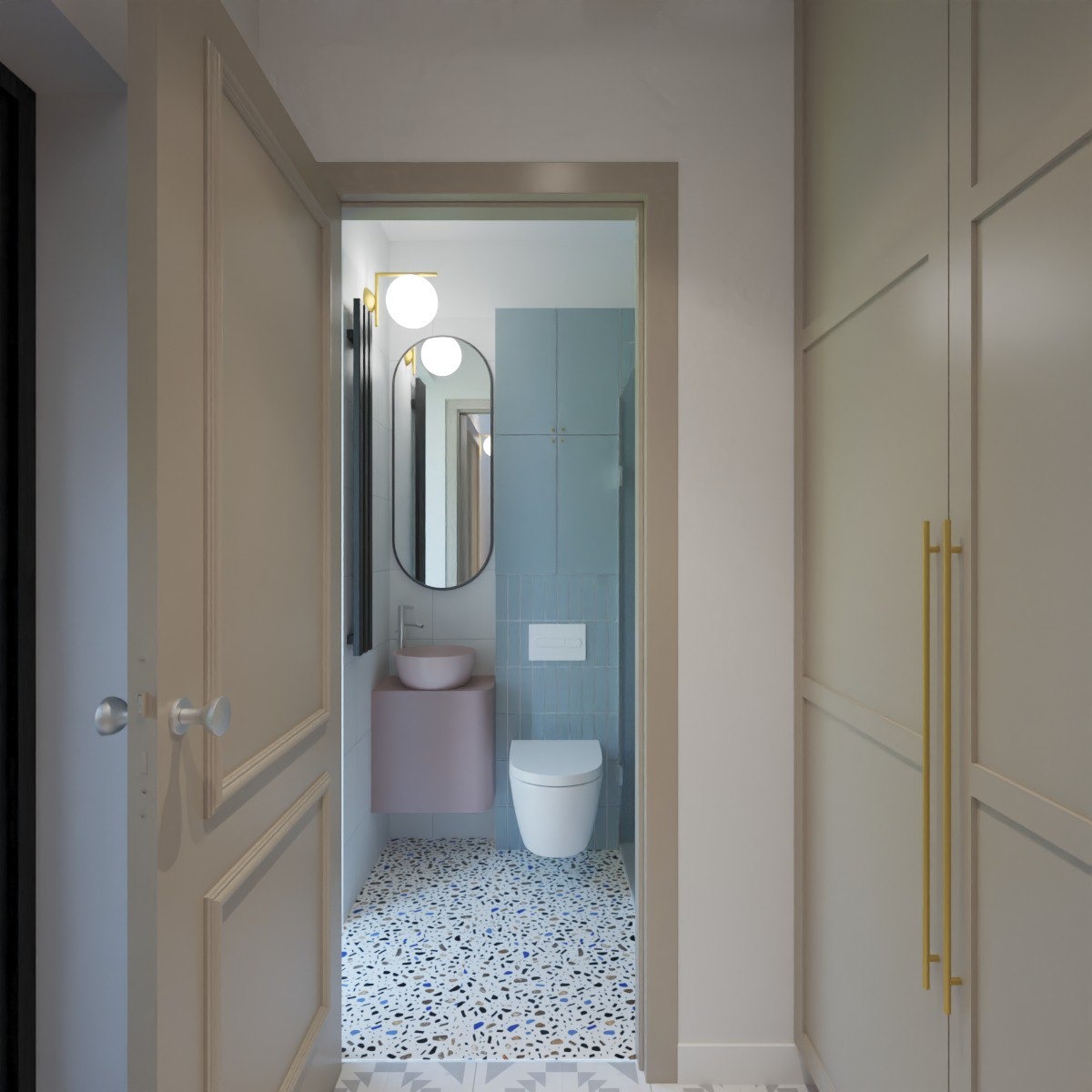 Nowoczesna łazienka z owalnym lustrem, różową umywalką i niebieskimi płytkami, widoczna z korytarza przez otwarte drzwi. Mozaika na podłodze dodaje wnętrzu charakteru.