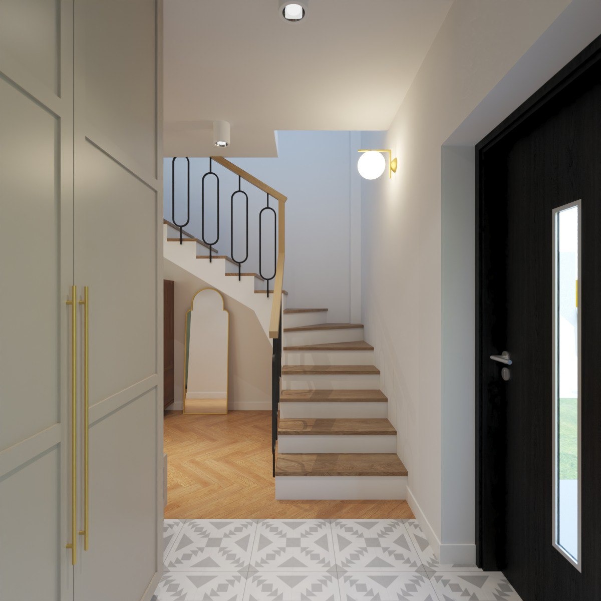 Jasne wnętrze domu: schody z drewnianymi stopniami, szara szafa z długimi złotymi uchwytami, wzorzysta podłoga i czarne drzwi z przeszkleniem.