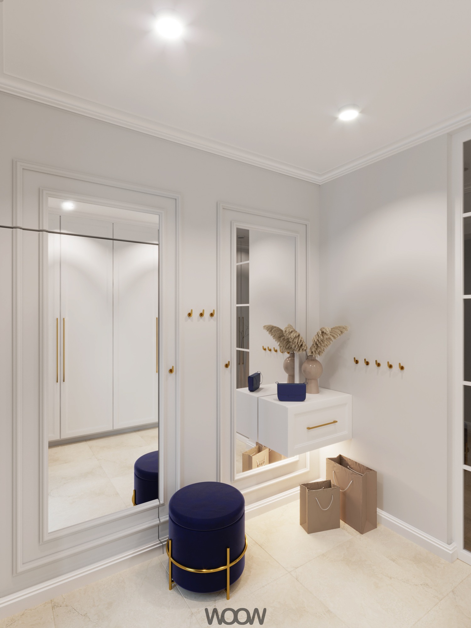 Elegancki przedpokój w jasnych barwach: lustra w białych ramach, granatowy puf ze złotymi akcentami, minimalistyczna konsola i dekoracje z suszonych traw.