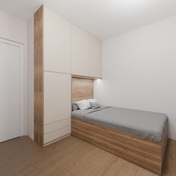WGC Michał Karpowicz - Nowoczesna szafa wnękowa z łóżkiem wkomponowanym w zabudowę, drewniane wykończenie i oświetlenie LED. Minimalistyczny design w jasnych kolorach.