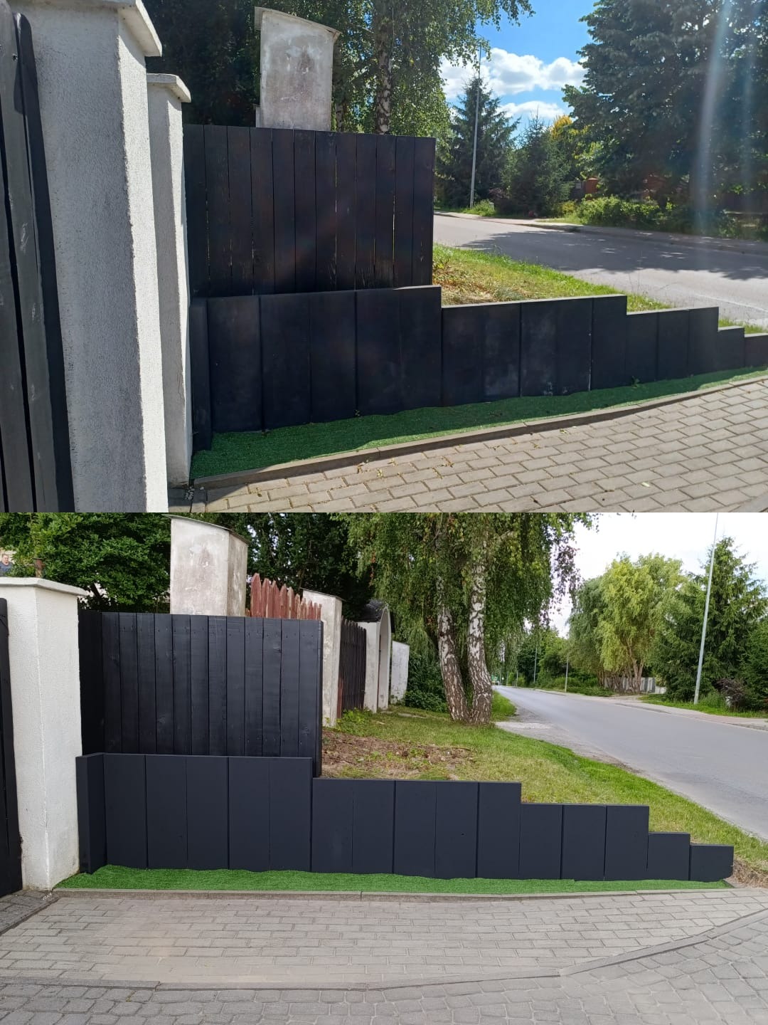 Czarne, schodkowe ogrodzenie z drewnianych desek i betonowych słupków, oddzielające posesję od ulicy, z imitacją trawy u podstawy. Słoneczny dzień, widok na drogę.