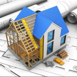 Model domu w trakcie budowy z niebieskim dachem, na planach architektonicznych. Widoczne elementy konstrukcyjne i materiały budowlane.