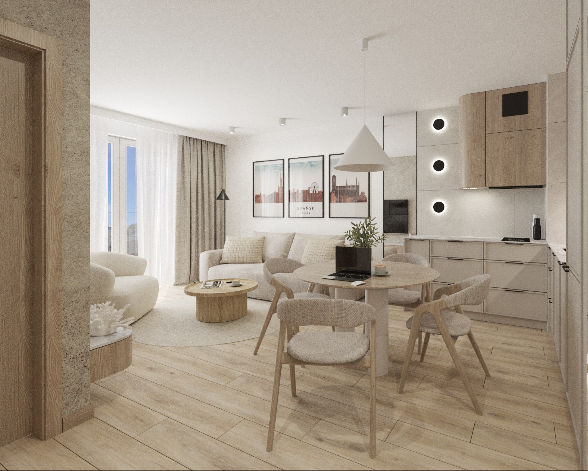 Jasne, przestronne wnętrze mieszkania z drewnianą podłogą, okrągłym stołem z laptopem i widokiem na salon z sofą i plakatami. Minimalistyczna kuchnia w tle.
