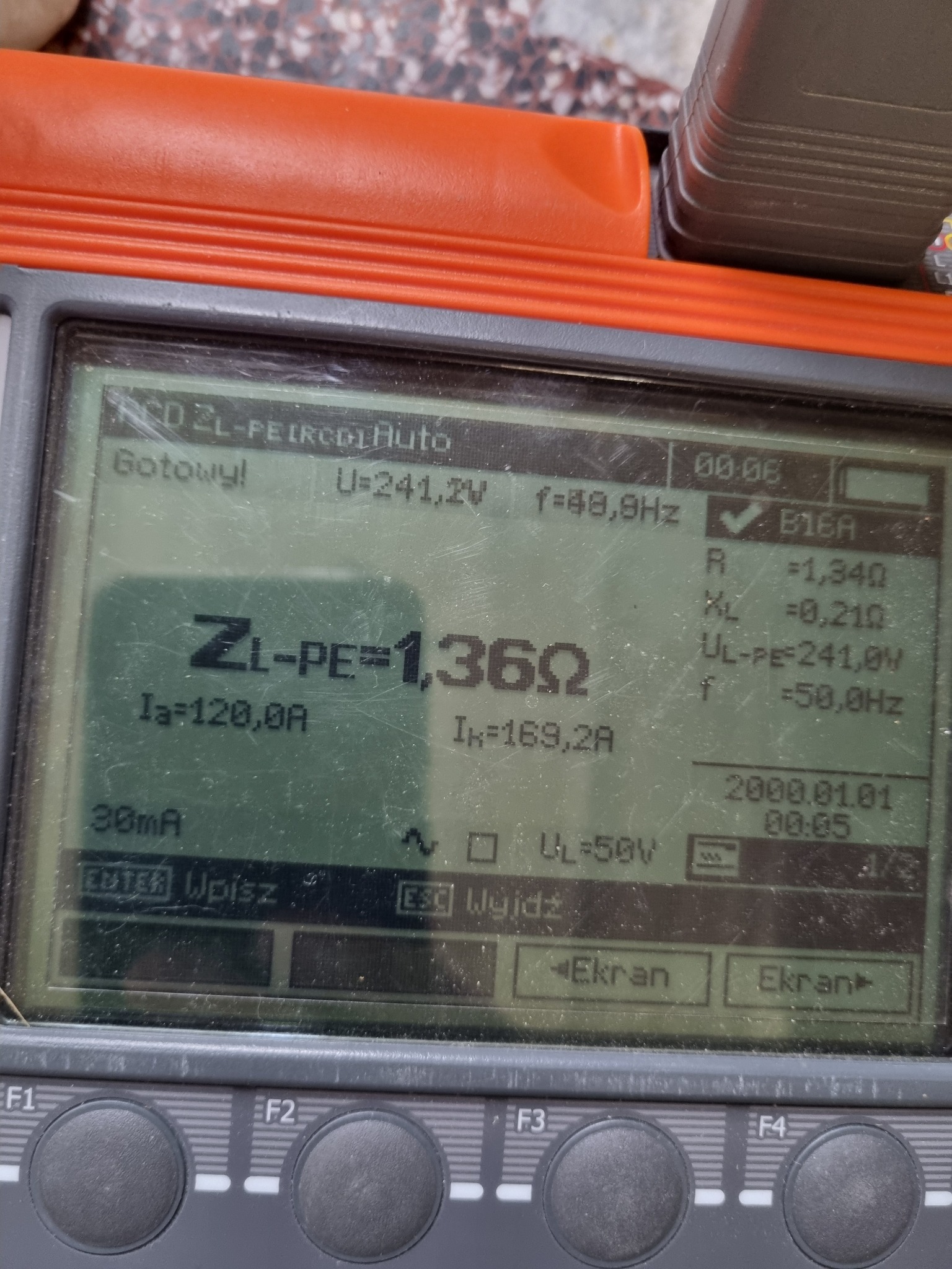 Ekran miernika elektrycznego z wynikami pomiarów ZL-PE=1,36Ω, Ia=120,0A, Ik=169,2A, U=241,2V i f=48,9Hz. Urządzenie w kolorze pomarańczowo-szarym.