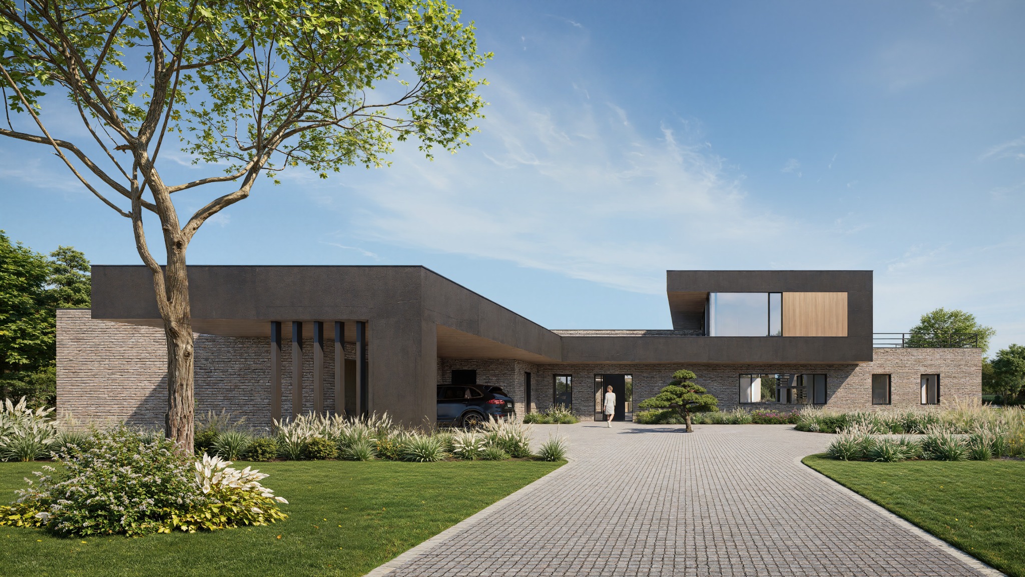 Nowoczesny dom jednorodzinny z płaskim dachem i elewacją z kamienia, z garażem w bryle budynku. Kobieta wchodzi do domu. Otoczenie: trawnik, drzewa, krzewy.