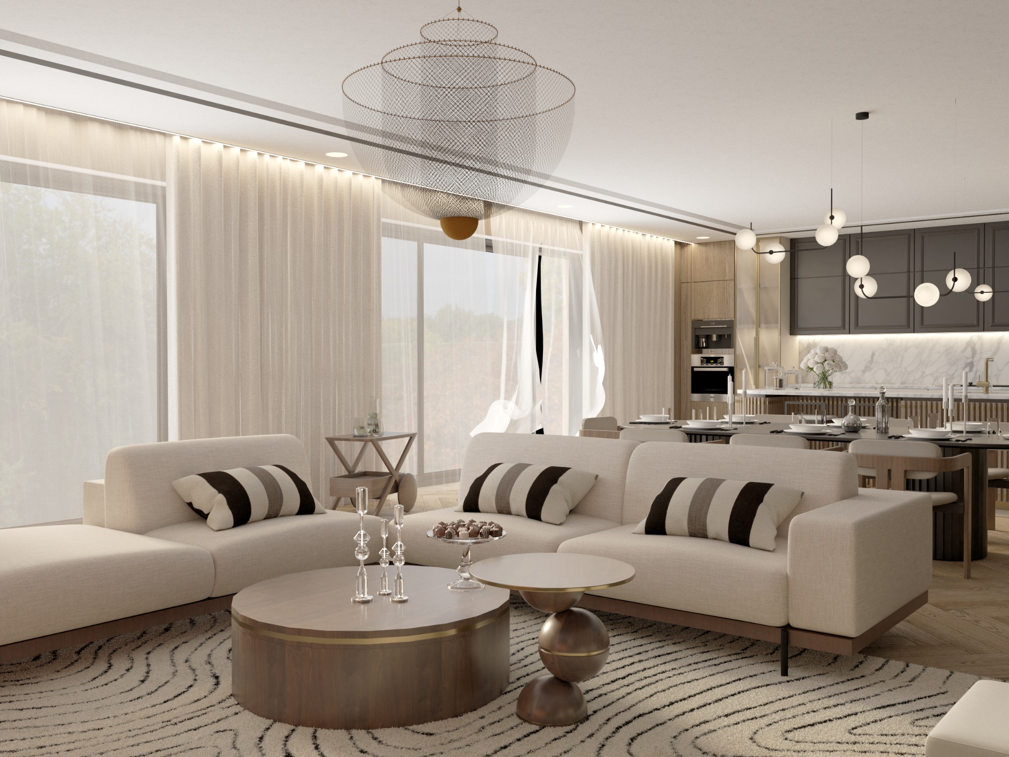 Jasny salon z beżową sofą, okrągłym stolikiem kawowym i wzorzystym dywanem. W tle widoczna kuchnia z marmurowym blatem i nowoczesnym oświetleniem.